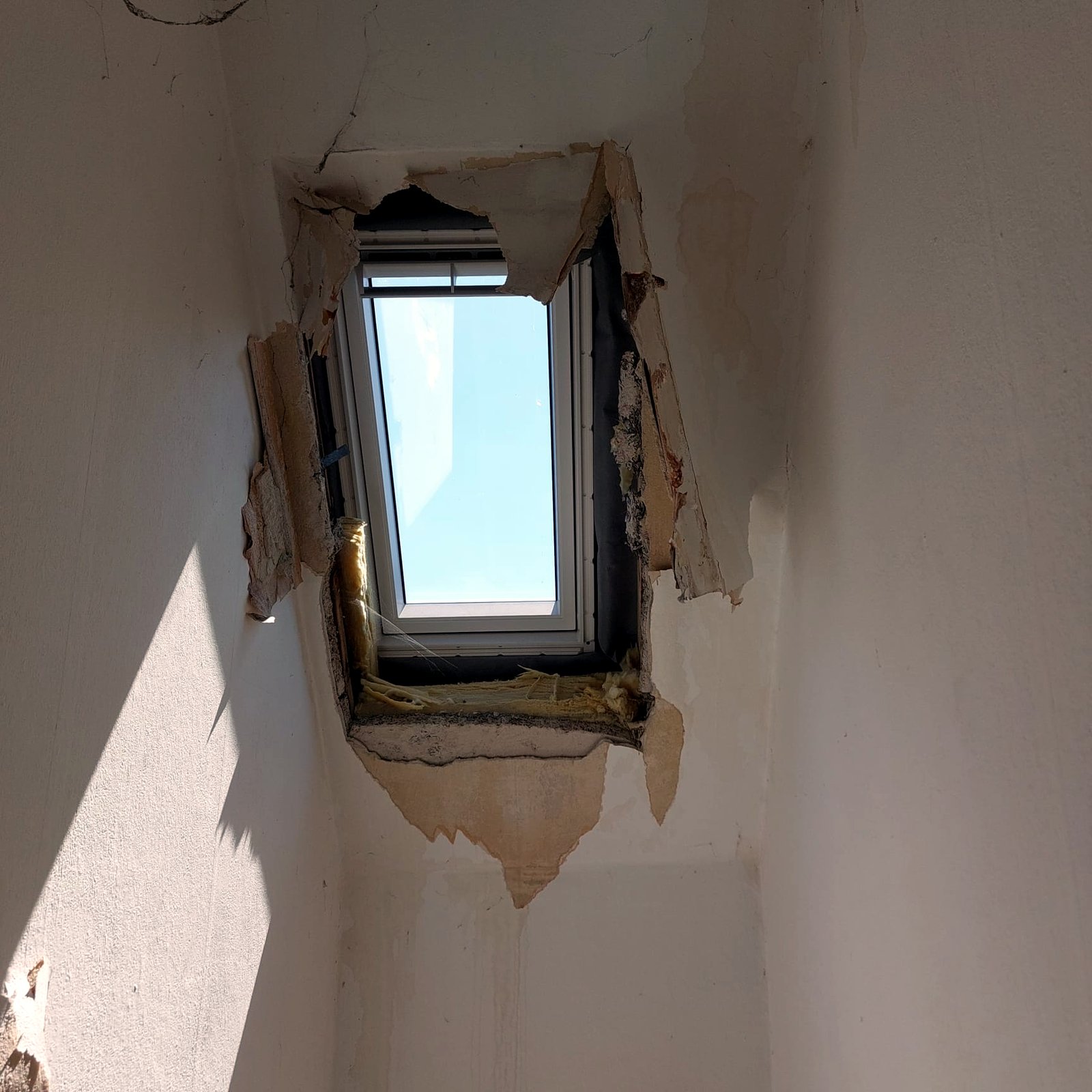 Rohzustand: geöffnete Dachschräge am Dachfenster vor dem Trockenbau